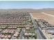 A high-angle perspective reveals a neighborhood's layout, showcasing uniform housing, roads, and community planning at 7775 Santos Bay Ct, Las Vegas, NV 89179