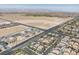 An aerial view showcases a well-planned community with modern homes and landscaped streets against a desert backdrop at 7775 Santos Bay Ct, Las Vegas, NV 89179