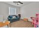 Cozy bedroom with a comfortable couch, desk, and ample space for playroom activities at 7775 Santos Bay Ct, Las Vegas, NV 89179