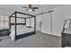 Elegant bedroom with a four-poster bed, barn door, neutral palette, and ample natural light at 7775 Santos Bay Ct, Las Vegas, NV 89179