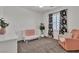 Bright Bedroom with crib, chair, and floral curtains at 7775 Santos Bay Ct, Las Vegas, NV 89179