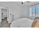 Bright bedroom with plush carpet, white walls, a ceiling fan, and natural light from window at 7775 Santos Bay Ct, Las Vegas, NV 89179