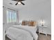 Bright bedroom featuring a queen bed, side tables, and carpet flooring at 7775 Santos Bay Ct, Las Vegas, NV 89179