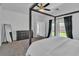 Spacious bedroom featuring a four-poster bed, modern decor, and access to outdoor view at 7775 Santos Bay Ct, Las Vegas, NV 89179