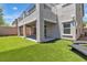 Home's exterior showing a covered patio and artificial turf lawn area at 7775 Santos Bay Ct, Las Vegas, NV 89179