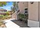 Home exterior featuring stucco siding, front garden with decorative stone and manicured landscaping at 7775 Santos Bay Ct, Las Vegas, NV 89179