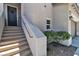 Inviting front entrance with stairs, a small garden area, and a black front door with a wreath at 7775 Santos Bay Ct, Las Vegas, NV 89179