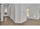 Bright hallway with hardwood floors and white trim, showcasing the home's clean and modern design at 7775 Santos Bay Ct, Las Vegas, NV 89179