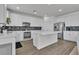 Modern kitchen with white cabinets, stainless steel appliances, an island, and stylish backsplash at 7775 Santos Bay Ct, Las Vegas, NV 89179