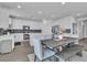 Eat-in kitchen featuring stainless appliances, white cabinets and modern tile backsplash at 7775 Santos Bay Ct, Las Vegas, NV 89179