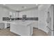 Modern kitchen with white cabinets, quartz counters, stainless appliances, and island at 7775 Santos Bay Ct, Las Vegas, NV 89179