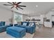 Open-concept living room showcasing a blue sectional sofa and island with eat-in kitchen at 7775 Santos Bay Ct, Las Vegas, NV 89179
