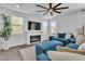 Bright living room with fireplace, TV, large windows, and contemporary furnishings at 7775 Santos Bay Ct, Las Vegas, NV 89179