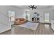 Open living room featuring wood floors, ample windows, and comfortable furniture at 7775 Santos Bay Ct, Las Vegas, NV 89179