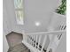 Carpeted staircase with white railing and window views at 7775 Santos Bay Ct, Las Vegas, NV 89179