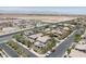 A street with modern houses, green lawns, and solar panels showcases a harmonious blend of nature and technology at 7775 Santos Bay Ct, Las Vegas, NV 89179