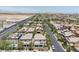 A tree-lined street with sidewalks showcases neighborhood charm and modern housing design, blending aesthetics at 7775 Santos Bay Ct, Las Vegas, NV 89179