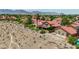 Aerial view of the neighborhood displaying red-tiled roofs, mature trees and green landscaping at 8229 Sedona Sunrise Dr, Las Vegas, NV 89128