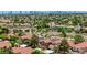 Aerial view showing the community, lush landscaping, and city skyline at 8229 Sedona Sunrise Dr, Las Vegas, NV 89128