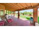 Covered back patio with comfortable seating and views of the landscaped backyard at 8229 Sedona Sunrise Dr, Las Vegas, NV 89128