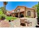 Beautiful backyard patio featuring a brick surface and an outdoor seating area with lush green grass at 8229 Sedona Sunrise Dr, Las Vegas, NV 89128