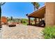 Paver backyard featuring a fire pit and covered patio with BBQ at 8229 Sedona Sunrise Dr, Las Vegas, NV 89128