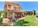 Spacious backyard featuring a covered patio with a seating area and a well-manicured lawn at 8229 Sedona Sunrise Dr, Las Vegas, NV 89128