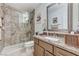 Well-lit bathroom featuring a granite countertop, a framed mirror, and a glass door shower at 8229 Sedona Sunrise Dr, Las Vegas, NV 89128