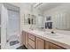 Bright bathroom with dual sinks and white tiled shower and separate toilet at 8229 Sedona Sunrise Dr, Las Vegas, NV 89128