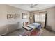 Minimalist bedroom with neutral colors, carpeted floors, ceiling fan and lots of natural light at 8229 Sedona Sunrise Dr, Las Vegas, NV 89128