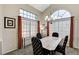 Bright dining room boasting large windows, modern lighting, and a beautiful table at 8229 Sedona Sunrise Dr, Las Vegas, NV 89128