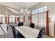 Elegant dining room featuring gorgeous windows, high ceilings and a decorative chandelier at 8229 Sedona Sunrise Dr, Las Vegas, NV 89128