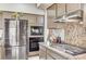Modern kitchen with stainless steel appliances and granite countertops at 8229 Sedona Sunrise Dr, Las Vegas, NV 89128