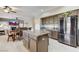 This is the kitchen with stainless steel refrigerator, granite countertops, and a center island with bar stools at 8229 Sedona Sunrise Dr, Las Vegas, NV 89128