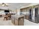 Bright open kitchen with stainless steel refrigerator, granite counters and breakfast nook at 8229 Sedona Sunrise Dr, Las Vegas, NV 89128
