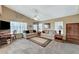 Cozy living room with vaulted ceiling, neutral tones, and backyard views at 8229 Sedona Sunrise Dr, Las Vegas, NV 89128