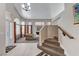 Spacious open-concept living room with staircase, featuring carpet and hard wood flooring at 8229 Sedona Sunrise Dr, Las Vegas, NV 89128