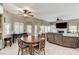 Open-plan dining and living area with hardwood floors, a fireplace, and modern ceiling fans at 8229 Sedona Sunrise Dr, Las Vegas, NV 89128