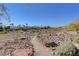 Scenic view of the neighborhood featuring a rocky terrain and a path leading to the residential area at 8229 Sedona Sunrise Dr, Las Vegas, NV 89128
