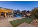 Expansive backyard featuring a pool, outdoor kitchen, putting green, and a cozy gazebo with a fire pit at 8713 Long Winter Ct, Las Vegas, NV 89131