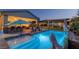 Beautiful backyard with a sparkling pool, outdoor kitchen, and gazebo with a cozy fire pit at 8713 Long Winter Ct, Las Vegas, NV 89131