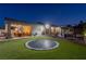 Large backyard with a trampoline, covered patio with dining area, and a gazebo with a fire pit at 8713 Long Winter Ct, Las Vegas, NV 89131