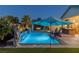 Lush backyard featuring a pool, lounge area, outdoor kitchen, and charming gazebo with a fire pit at 8713 Long Winter Ct, Las Vegas, NV 89131