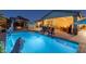 Spacious backyard with a pool, outdoor kitchen, dining area, and cozy gazebo with a fire pit at 8713 Long Winter Ct, Las Vegas, NV 89131