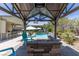 Relaxing backyard features a custom pool with a fire pit, and outdoor kitchen for entertaining at 8713 Long Winter Ct, Las Vegas, NV 89131