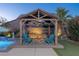 Inviting backyard showcasing a charming gazebo with a cozy fire pit and lush landscaping at 8713 Long Winter Ct, Las Vegas, NV 89131