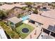 Aerial view of a backyard featuring a pool, trampoline, covered patio, and lush landscaping at 8713 Long Winter Ct, Las Vegas, NV 89131