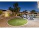 Beautiful backyard featuring a covered jacuzzi, artificial turf, and ample space for outdoor enjoyment at 8713 Long Winter Ct, Las Vegas, NV 89131
