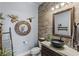 Charming powder room with wood-look tile, decorative mirrors, and vessel sink at 8713 Long Winter Ct, Las Vegas, NV 89131