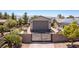 View of the property showcasing the private gate, brick accents, and desert landscaping at 8713 Long Winter Ct, Las Vegas, NV 89131